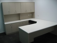 Custom Desk With Truncated Corner. Return With Special Back Credenza With Doors And Drawers. Overhead Hutch With Doors